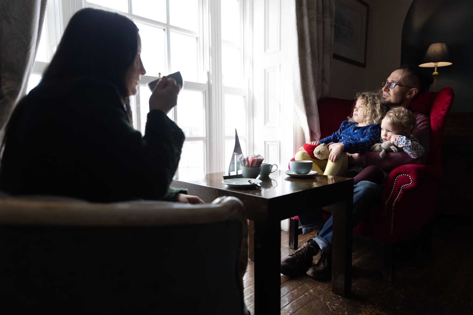 A family relaxing together in hotel lounge